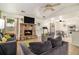 Cozy living room features a stone fireplace, tile floors, ceiling fans, and comfortable seating for relaxing at 7845 Chase Woods Dr, Jonesboro, GA 30236