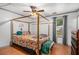 Tranquil bedroom featuring a four-poster bed, hardwood floors, and ample natural light at 7845 Chase Woods Dr, Jonesboro, GA 30236