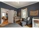 This stylish Bedroom features a cozy chair, two white cribs, and light-filled windows for a peaceful atmosphere at 206 Flora Ne Ave, Atlanta, GA 30307
