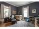 Cozy Bedroom features natural light, a white crib, reading chair, and charming décor for a warm and inviting space at 206 Flora Ne Ave, Atlanta, GA 30307