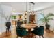 Open-concept area with round table, emerald chairs, and view of the kitchen at 206 Flora Ne Ave, Atlanta, GA 30307