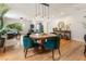 Open-concept living space featuring hardwood floors, round table, and stylish emerald green chairs at 206 Flora Ne Ave, Atlanta, GA 30307
