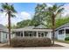 Charming home featuring a welcoming porch, complemented by lush landscaping and mature palm trees at 206 Flora Ne Ave, Atlanta, GA 30307