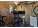 The shed has been converted to an office with plywood walls, shelving, and a modern desk at 206 Flora Ne Ave, Atlanta, GA 30307