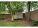 Backyard shed with yellow siding and mature trees at 206 Flora Ne Ave, Atlanta, GA 30307