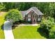Expansive front lawn with circular driveway leading to a two-story brick home with mature trees at 213 Shady Valley Dr, Carrollton, GA 30116