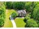 Lush trees surround two-story brick home featuring long drive and expansive green lawn at 213 Shady Valley Dr, Carrollton, GA 30116