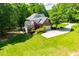 Aerial view of this wooded property and the home's attractive backyard and driveway at 213 Shady Valley Dr, Carrollton, GA 30116