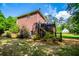 Exterior view features a deck, brick facade, and lush landscaping at 213 Shady Valley Dr, Carrollton, GA 30116