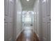 Hallway view of the bathroom showing a tub, shower, and vanity, enhanced by natural light from a large window at 213 Shady Valley Dr, Carrollton, GA 30116