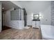 Spacious bathroom featuring a glass block shower, soaking tub, and white vanity at 213 Shady Valley Dr, Carrollton, GA 30116