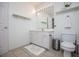 Bright bathroom with a single vanity and toilet, featuring a neutral tile floor at 213 Shady Valley Dr, Carrollton, GA 30116