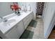Bright bathroom featuring a double vanity with a large mirror and a shower with patterned curtain at 213 Shady Valley Dr, Carrollton, GA 30116