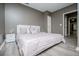 Modern bedroom with stylish gray walls, sleek white furniture, and tiled floors at 213 Shady Valley Dr, Carrollton, GA 30116