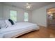 Bright bedroom with hardwood floors, two windows and a door to the bathroom at 213 Shady Valley Dr, Carrollton, GA 30116
