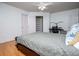 Bright bedroom features hardwood floors, ceiling fan and a walk-in closet with built-in shelving at 213 Shady Valley Dr, Carrollton, GA 30116
