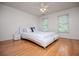 Bedroom features hardwood floors, two windows with blinds, and white furniture at 213 Shady Valley Dr, Carrollton, GA 30116
