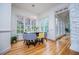 Modern dining room with large windows, contemporary light fixture, and hardwood flooring at 213 Shady Valley Dr, Carrollton, GA 30116