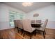 Dining room with hardwood floors, natural light, and a modern light fixture at 213 Shady Valley Dr, Carrollton, GA 30116