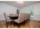 A formal dining room featuring hardwood floors, white trim, and a modern light fixture at 213 Shady Valley Dr, Carrollton, GA 30116