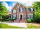 Elegant brick home featuring multiple windows with black shutters and a well-maintained yard at 213 Shady Valley Dr, Carrollton, GA 30116