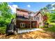 Brick home boasts a back deck with great view and backyard patio beneath at 213 Shady Valley Dr, Carrollton, GA 30116