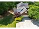 Aerial view of the brick home features a two-car garage, beautiful landscaping, and an expansive driveway at 213 Shady Valley Dr, Carrollton, GA 30116