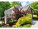 A beautifully landscaped yard and wooded setting surround this brick home at 213 Shady Valley Dr, Carrollton, GA 30116