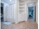 Hallway features built-in shelving, tiled floors and a shower with a floral curtain at 213 Shady Valley Dr, Carrollton, GA 30116