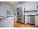 Modern kitchen with stainless steel appliances and white cabinets at 213 Shady Valley Dr, Carrollton, GA 30116