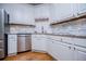 Bright kitchen features white cabinets, granite countertops, stainless steel appliances, and stone backsplash at 213 Shady Valley Dr, Carrollton, GA 30116