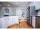 Modern kitchen featuring stainless steel appliances, white cabinets, and a cozy atmosphere at 213 Shady Valley Dr, Carrollton, GA 30116