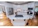 Spacious kitchen with stainless appliances, white cabinets, and a central island at 213 Shady Valley Dr, Carrollton, GA 30116