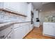 Modern kitchen featuring stainless steel appliances, white cabinets, and granite countertops at 213 Shady Valley Dr, Carrollton, GA 30116