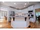 Bright kitchen with stainless appliances, white cabinets, and hardwood floors at 213 Shady Valley Dr, Carrollton, GA 30116