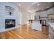 Spacious living room with hardwood floors, fireplace, and natural light with kitchen and dining areas at 213 Shady Valley Dr, Carrollton, GA 30116