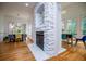 Bright living room featuring a stone fireplace and open dining area at 213 Shady Valley Dr, Carrollton, GA 30116