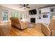 Spacious living room with built-in shelving, fireplace, and hardwood floors at 213 Shady Valley Dr, Carrollton, GA 30116
