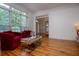 Bright living room with hardwood floors, stylish furniture, and view of outdoor greenery at 213 Shady Valley Dr, Carrollton, GA 30116