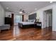 Large bedroom offers hardwood floors, ceiling fan, and a window view complemented by dark wood furniture at 213 Shady Valley Dr, Carrollton, GA 30116