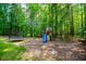 Backyard with a playground, swing set, and a trampoline at 213 Shady Valley Dr, Carrollton, GA 30116