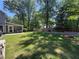 Spacious backyard offering mature trees, manicured lawn, and privacy fencing at 4080 Longford Ne Dr, Marietta, GA 30066