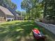 Expansive backyard featuring a patio, screened porch, and lush green lawn at 4080 Longford Ne Dr, Marietta, GA 30066
