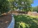 Beautifully landscaped backyard with a retaining wall and a newly stained wood fence at 4080 Longford Ne Dr, Marietta, GA 30066