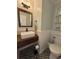 Stylish bathroom featuring patterned floors, wood vanity, and modern fixtures at 4080 Longford Ne Dr, Marietta, GA 30066