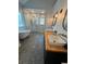 Bright bathroom featuring a soaking tub, glass shower, and double vanity with wood countertop at 4080 Longford Ne Dr, Marietta, GA 30066
