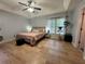 Tranquil bedroom features hardwood floors, neutral tones, and a ceiling fan above the bed with side tables at 4080 Longford Ne Dr, Marietta, GA 30066