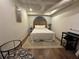 Modern bedroom featuring light walls, wood flooring, a large bed, and a small work space at 4080 Longford Ne Dr, Marietta, GA 30066