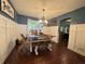 Charming dining room featuring wood floors, board and batten walls and a modern chandelier at 4080 Longford Ne Dr, Marietta, GA 30066