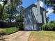 Exterior view featuring a two-car garage, a screened porch, and manicured landscaping at 4080 Longford Ne Dr, Marietta, GA 30066